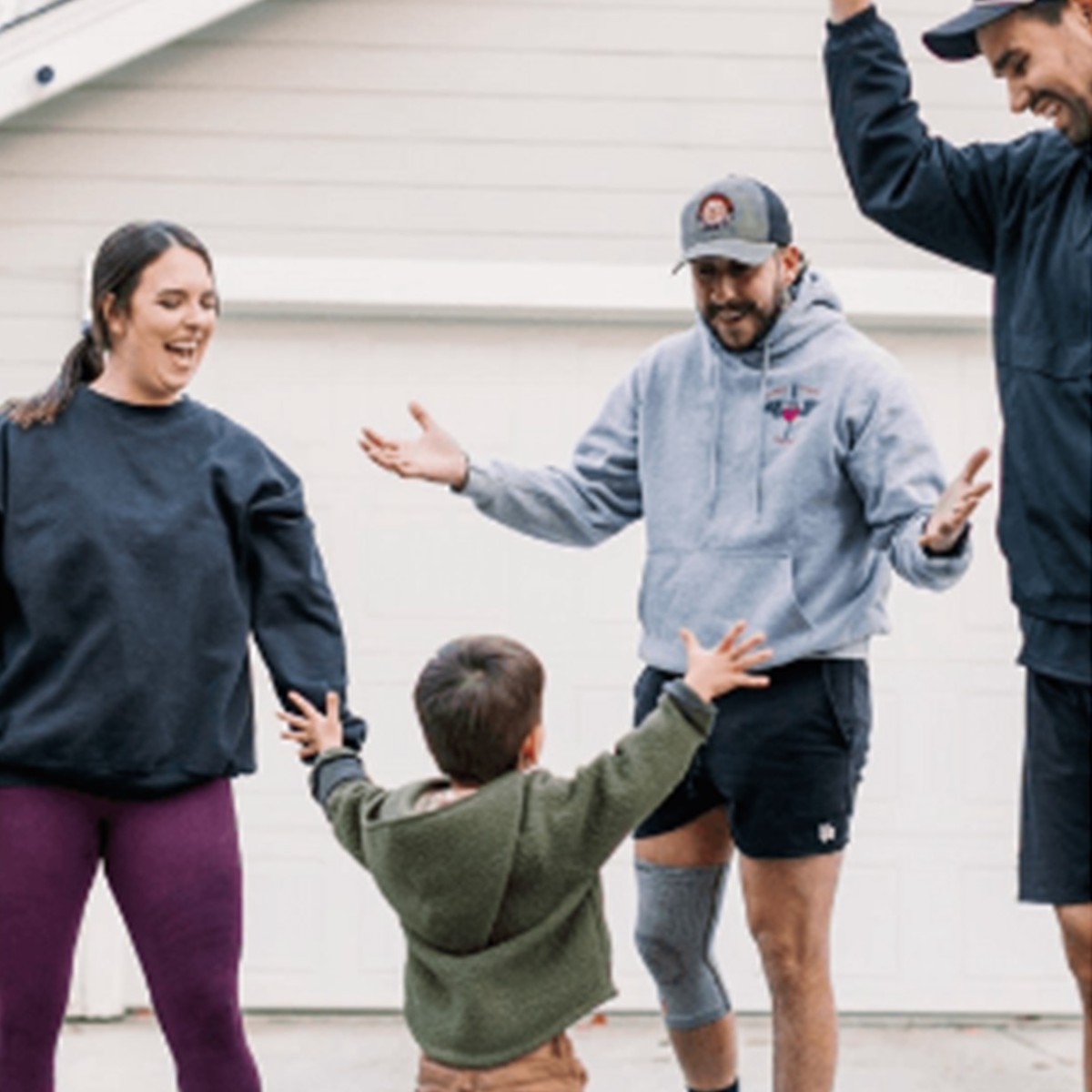 A personal trainer meets with a family outside their home in Chico, CA, showing the friendly, community-focused approach of in-home workouts with Gym Truck Chico.